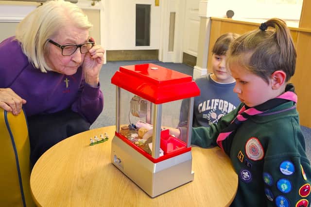 Delighted Elm Bank Care Home resident enjoying the evening with a young Scout