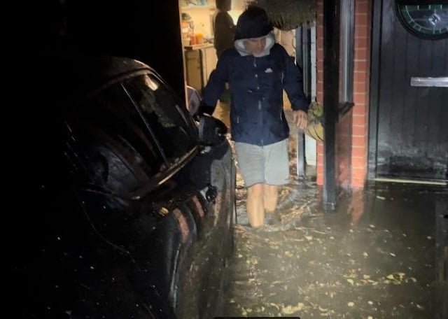 Residents in Waverley Road wading through the floodwater