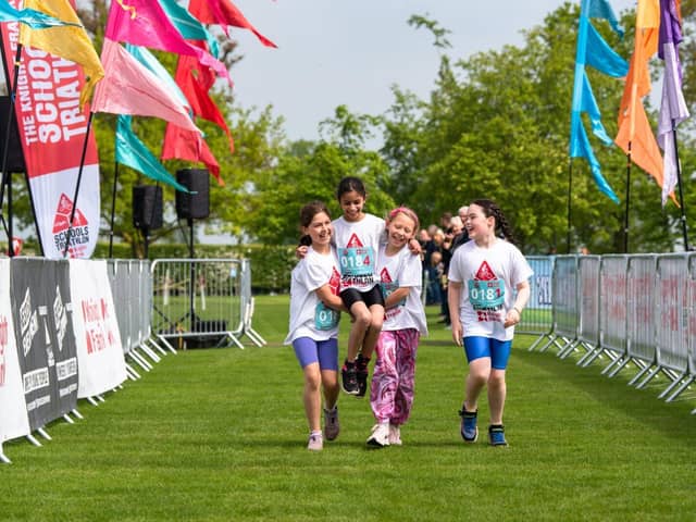 A team crossing the finish line at the 2023 Oundle triathlon