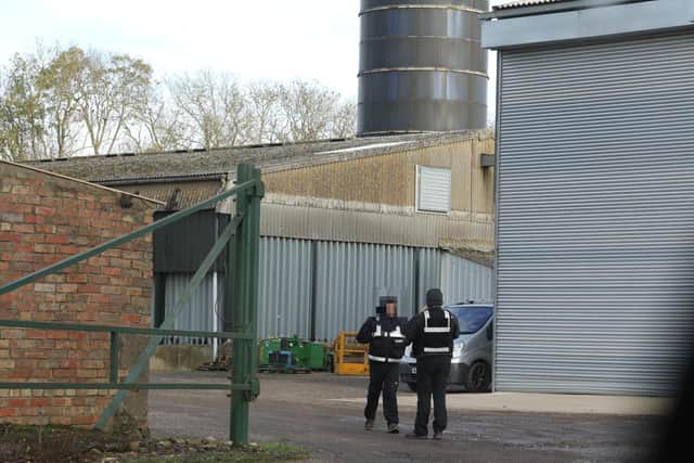 Security guards patrol outside one of the turkey farms near Oundle where avian (bird) flu has been detected