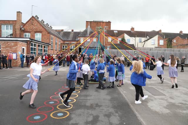 Children entertained the guests with a display of Maypole dancing in the playground