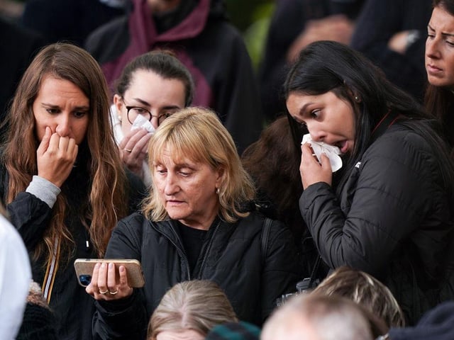 Mourners watched the funeral service on mobile phones while paying their respects