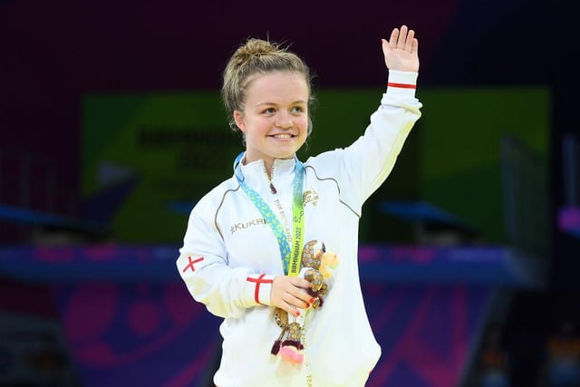 Maisie Summers-Newton waves to the crowd at the medal ceremony at the Commonwealth Games