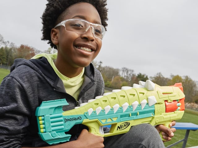 Team up with legendary dinosaurs as a member of the elite DinoSquad! Harness the extraordinary force of the greatest dinosaurs of all and blast into amazing adventures! Charge into action with the Nerf DinoSquad Armorstrike blaster! It features an awesome dinosaur design, capturing the look of an Anklyosaurus dinosaur. Launch 8 darts in a row from the blaster's 8-dart rotating drum to show your targets that you have plenty of dino-power! Pump the drop grip to prime the blaster and take advantage of its below-the-barrel design to steady your aim. The blaster includes 16 Official Nerf Elite foam darts - 8 darts to load the drum and 8 darts for reloads. And you can keep those 8 backup darts nearby because the blaster has onboard dart storage. To play, load the drum, move the drop grip backward and forward to prime the blaster, and pull the trigger to unleash 1 dart. Eyewear recommended (not included). No batteries required. £38.99, Ages 8+.