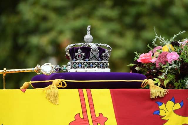 LONDON, ENGLAND - SEPTEMBER 19: The coffin of Queen Elizabeth II with the Imperial State Crown resting on top is carried by the Bearer Party as it departs Westminster Abbey during the State Funeral of Queen Elizabeth II on September 19, 2022 in London, England. (Photo by Joe Maher/Getty Images)