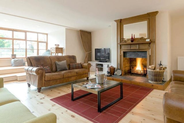 The primary living room provides seating comfortable enough for 10+and has a stunning open fire and large window seat overlooking the courtyard.