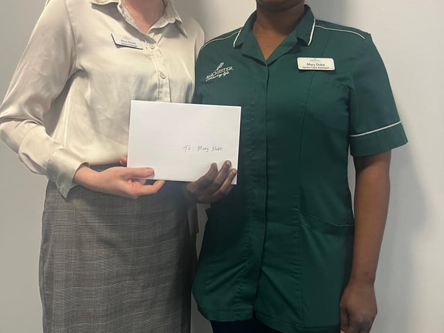General Manager Elina House presents the £100 voucher as way of a thank you for all the staffs hard work and dedication to the home.