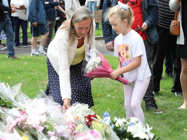 Families placed flowers in memory of the late Queen