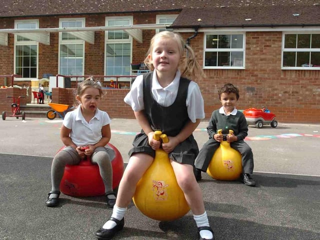 Corby, Old Village School, reception children settling in to the new term. l-r Amy Gradinariu, 4, Chloe Thorpe, 4, Alejandro Da Silva, 4, Thursday 9th September 2010