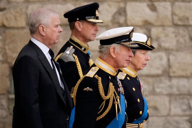 Prince Andrew, Duke of York, Prince Edward, Earl of Wessex, King Charles III and Anne, Princess Royal watch on as The Queen's funeral cortege borne on the State Gun Carriage of the Royal Navy departs Westminster Abbey