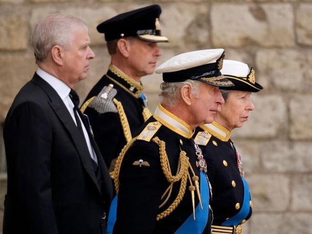 Prince Andrew, Duke of York, Prince Edward, Earl of Wessex, King Charles III and Anne, Princess Royal watch on as The Queen's funeral cortege borne on the State Gun Carriage of the Royal Navy departs Westminster Abbey