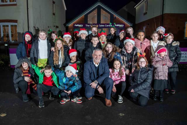 Ashberry Homes Sales Manager Kenny Lattimore with pupils from Loatlands Primary School who came to The Wickets development in Desborough to sing carols and spread some festive cheer.