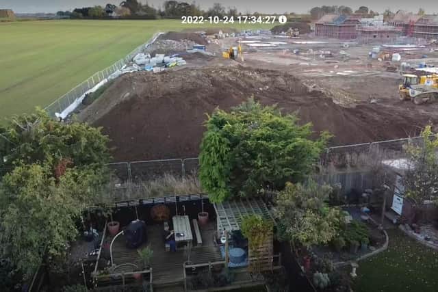 The mountain of soil and rubble looms over the back gardens