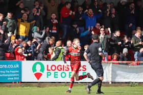 Jimmy Knowles celebrates in front of the delighted Kettering Town fans after opening the scoring from the penalty spot. Pictures by Peter Short