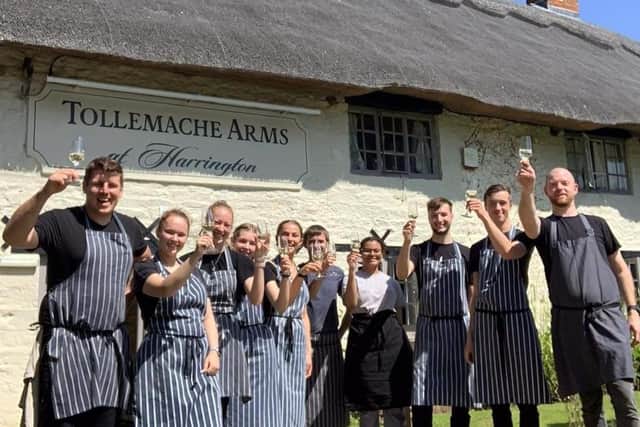 Staff at the Tollemache Arms celebrate.