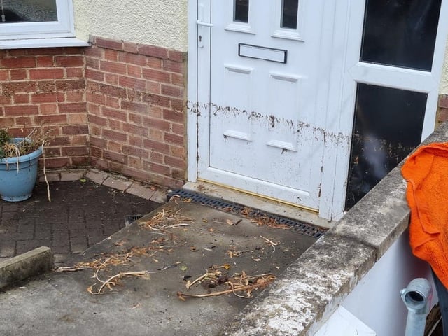 The depth of the flooding can be seen with the 'high tide' mark on a front door in Silverwood Road, Kettering