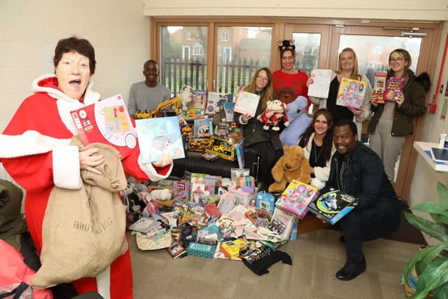 Mother Christmas Jeanette Walsh with the first load of toys and gifts delivered to social workers