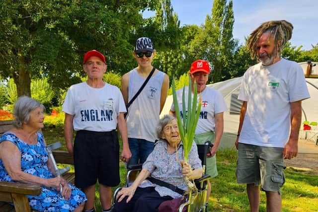 Residents admiring the fresh produce, with the fantastic volunteers at The Green Patch.
