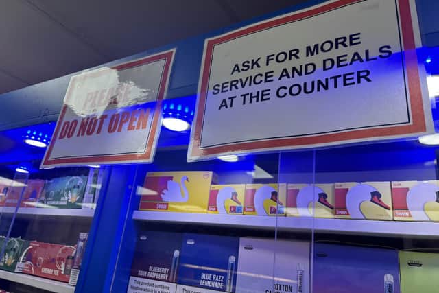 Signs above the legitimate sales items direct customers to ask behind the counter for 'deals'. Image: National World