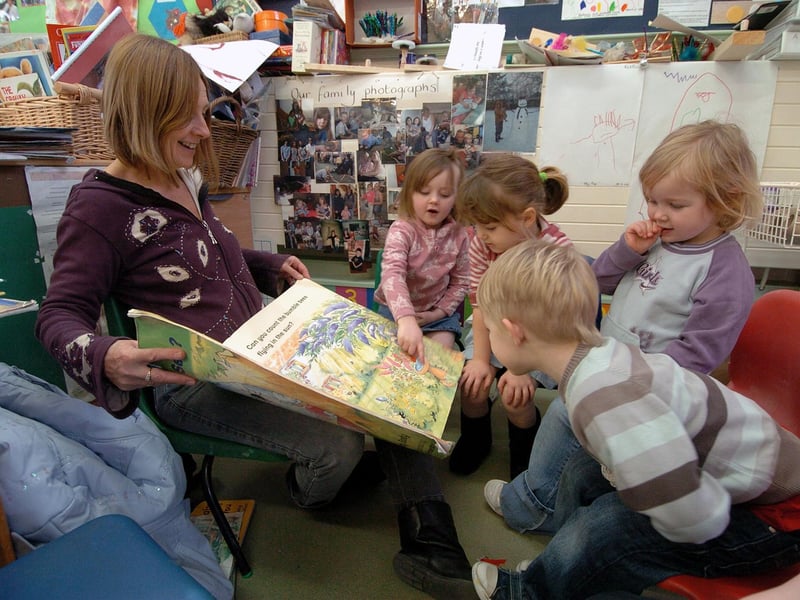 Margaret Myles (family worker) reads a story to some of the children in 2010.
