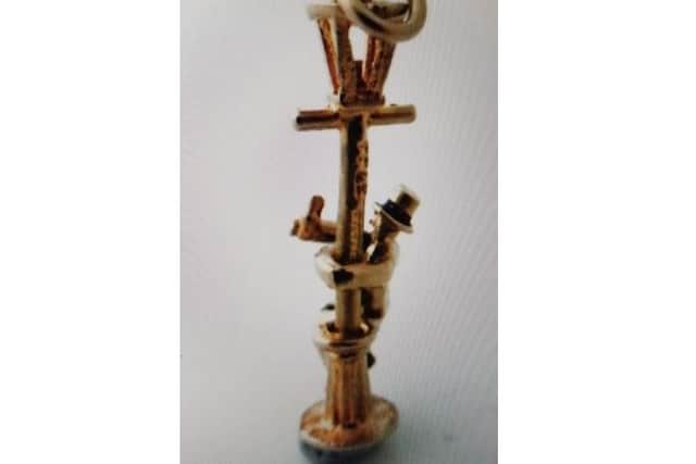 The pendant of the drunken man swinging on a lamppost