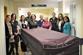 The new end-of-life trolley with some of the staff involved in its development.