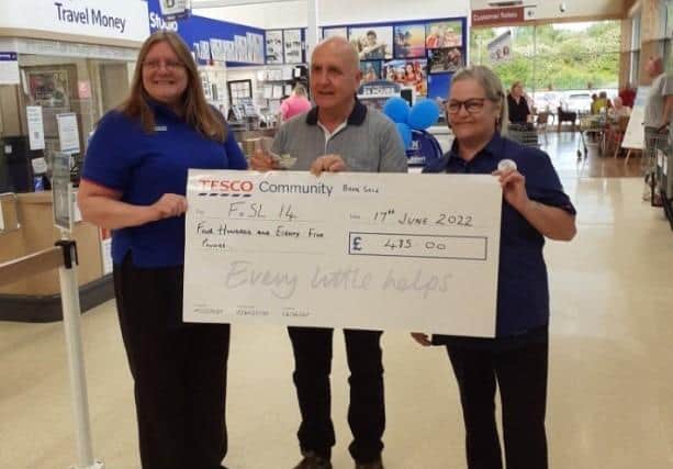 Tesco staff hand over their cheque to Friends of S&L 14