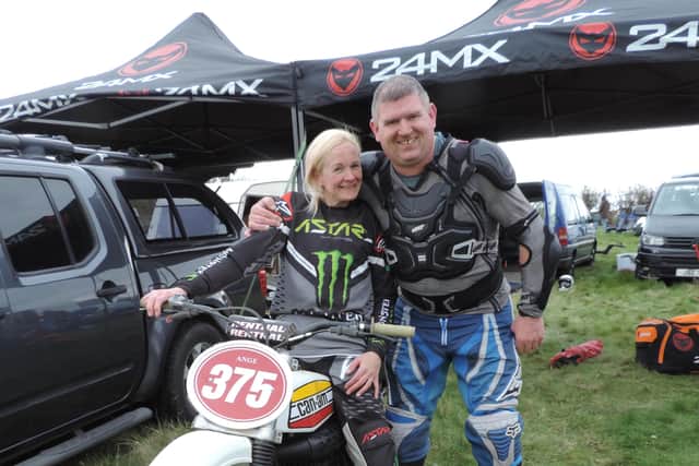 Rider Jim Denby gives Ange Harrop a hug for riding so well in only her second scramble. Harrop rides an American 175 Can-Am, chosen because it is relatively easy to start. Credit: Brian Crichton.