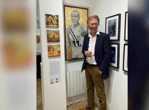 Brendan Reilly with his artwork at the exhibition
