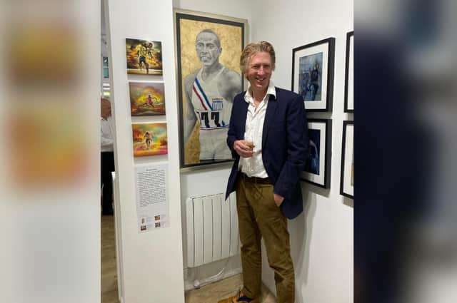 Brendan Reilly with his artwork at the exhibition