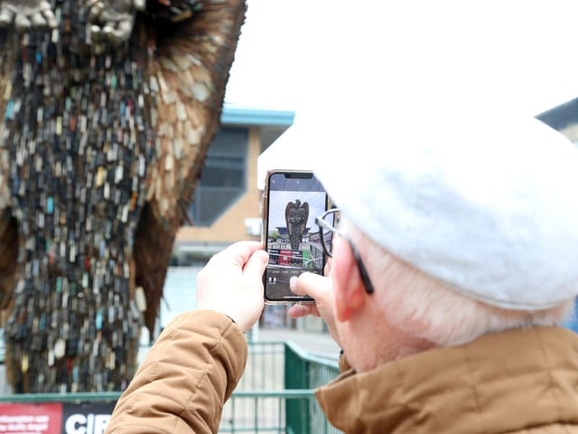 A resident takes a photo of the Knife Angel on a visit to Corporation Street on Sunday