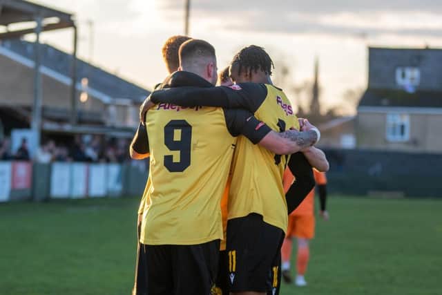 Jenson Cooper takes the congratulations after he opened the scoring in AFC Rushden & Diamonds' 2-1 win over St Ives Town on Monday. Picture by Hawkins Images