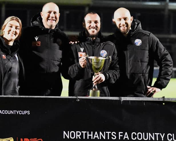 Michael Harriman and his backroom team show off the NFA Hillier Senior Cup after their win over Kettering Town (Picture: Shaun Frankham)