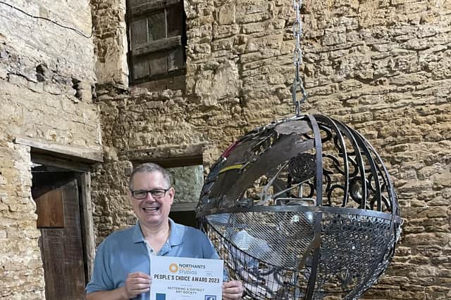 Dave Pearson with his metal sculpture 'Scrap Sphere'