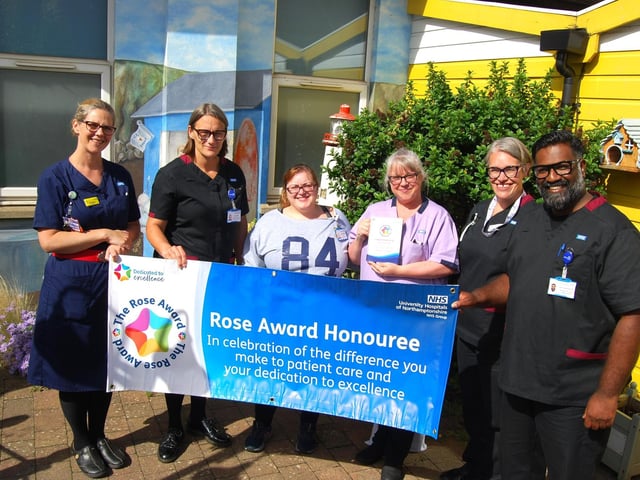 Toni Hancox receives her award with her colleagues.