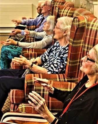 Residents taking part in arm chair exercises