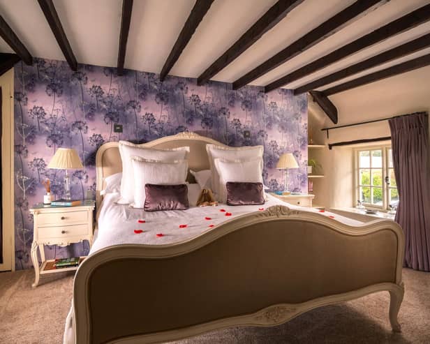 Master bedroom with loving red roses on the duvet