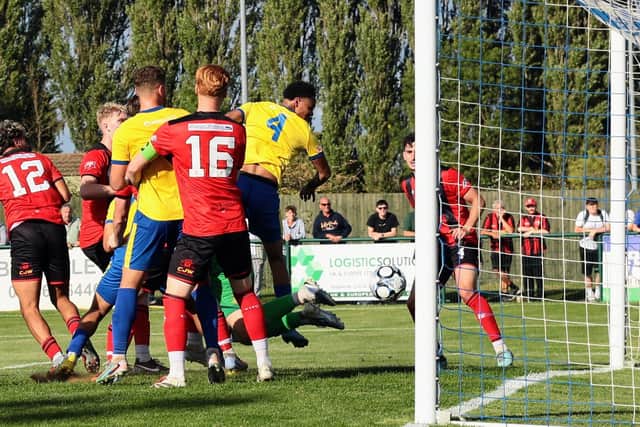 Rhys Kelly heads home Wellingborough Town's late equaliser against Kettering Town (Picture: Rob Webb)