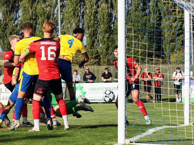 Rhys Kelly heads home Wellingborough Town's late equaliser against Kettering Town (Picture: Rob Webb)