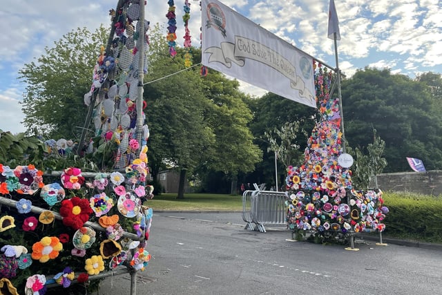 Local people have crocheted flowers for one of three traditional archway entrances to the village