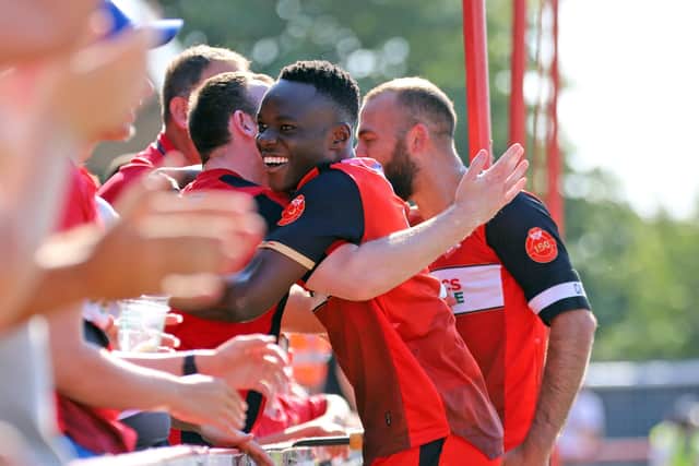 Andrew Oluwabori celebrates his goal with the Poppies fans