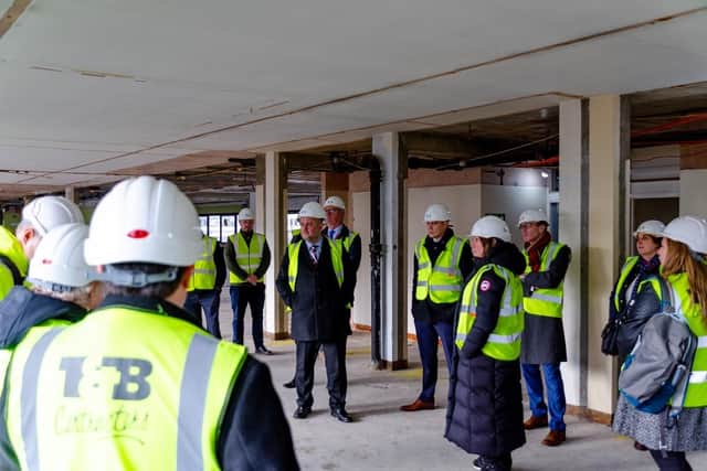 The VIPs tour the Chisholm House site