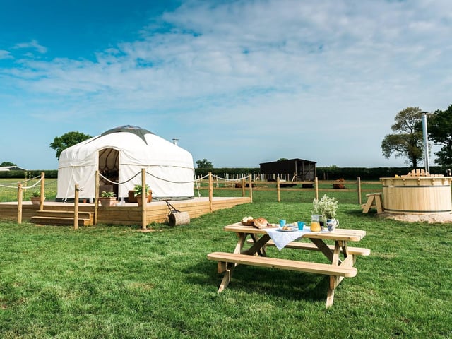 This boutique glamping site is situated in Helmdon, Northamptonshire, and you can choose between a yurt, wagon or tipi in the middle of a wheat field. Hot tubs, king size beds and wood burning stoves are among the luxuries at this destination.
