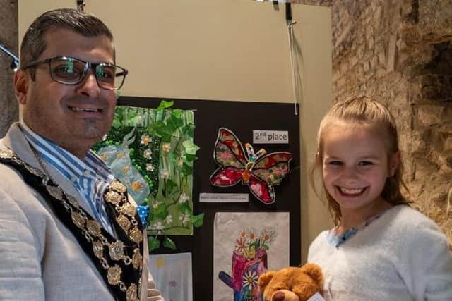 Evelyn French shows off her butterfly entry, 2nd place in the 7-8 year age group