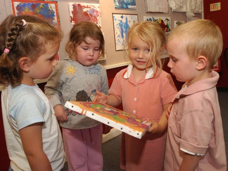 Lucy Issitt, 3, shows her friends her artwork in 2006