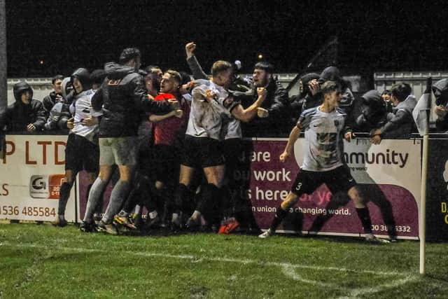 The Corby Town players and fans celebrate Curtis Burrows' last-gasp winner at Steel Park. Pictures by Jim Darrah
