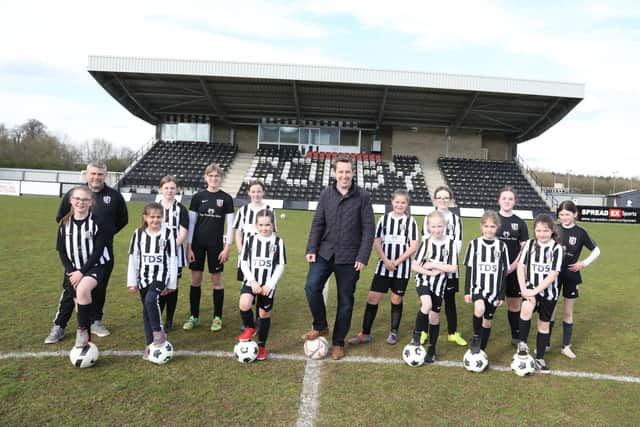 MP Tom Pursglove with U9s and U12s Corby Town FC team and coach Phil Toon