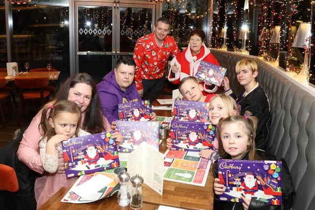 The Jenkins family tuck into a meal at Prezzo Corby thanks to Jeanette Walsh (Mother Christmas) and Simon Brunskill (manager)