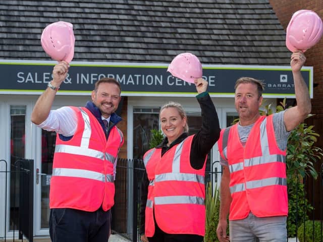 B&amp;DWC - SGB-15211 - Barratt Homes staff outside the Bertone Gardens sales centre in their pink PPE