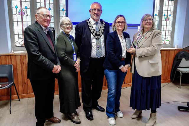 One topic under discussion at Northamptonshire Heritage Forum’s History Day held in Higham Ferrers, was the story of the fascinating flint axe. A replica was made for the session attended by, from the left: Martin Gaskell, chair of the Forum, Liz Barnatt, chair of Higham Ferrers Tourism (HTC), Mayor Gary Salmon, Professor Sarah Scott, and Carol Fitzgerald of HTC, Chichele College Management Committee and The Friends of St Mary’s.